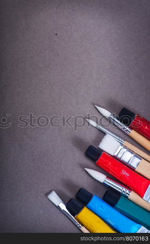 paint and brushes on the black table