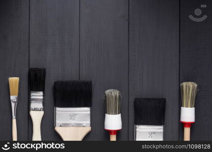 paint brush on plank wooden board table background texture