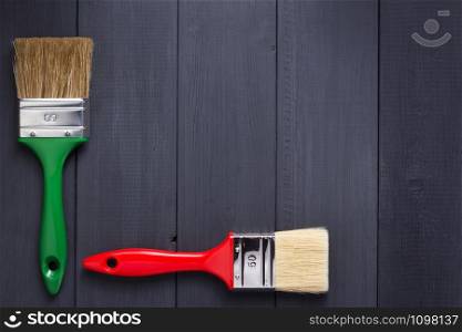 paint brush on plank wooden board table background texture