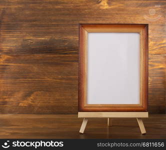 paint frame on wooden background