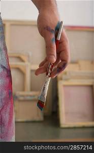 Paint on Artist&acute;s Hand and Paintbrush