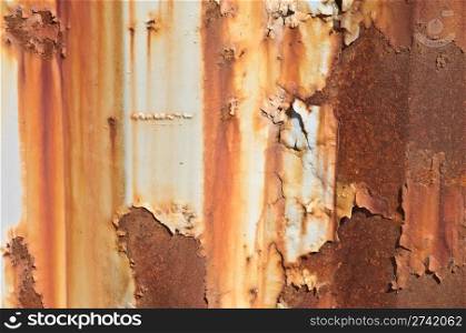 Paint peeling off a rusty metal background.