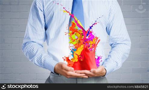 Paint splashes. Close up of businessman with paint splashes in hands
