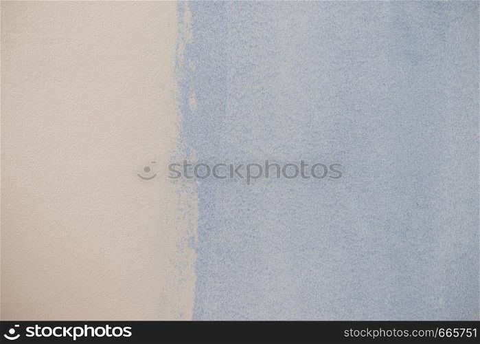 Paint swatch on white wall. Baby blue vintage color comparison to light. Texture, patterns and colorful background concept.. Blue paint swatch on white wall