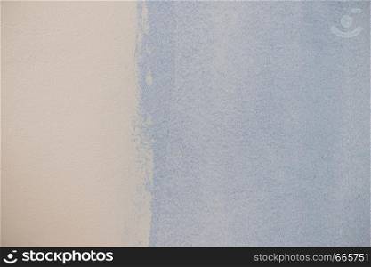 Paint swatch on white wall. Baby blue vintage color comparison to light. Texture, patterns and colorful background concept.. Blue paint swatch on white wall