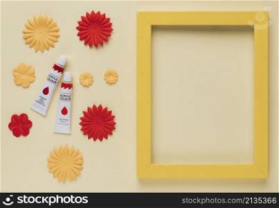 paint tube flower cutout yellow wooden frame border beige background