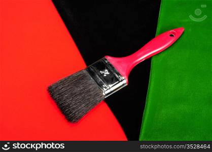 Paintbrush On Black, Red And Green Background.