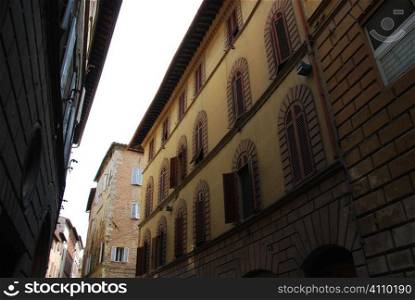Painted building facades in Siena, Tuscany, Italy