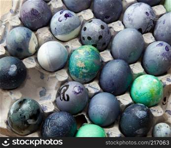 Painted chicken eggs in a tray . Easter bacground, flat lay. painted blue eggs in the tray
