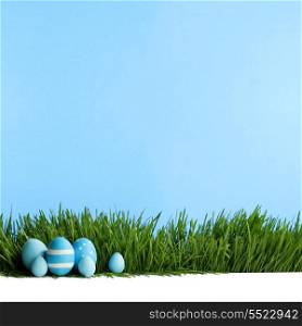 Painted Easter eggs hidden in the grass, isolated on white with copy space