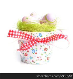 painted easter eggs on green in decorative bowl