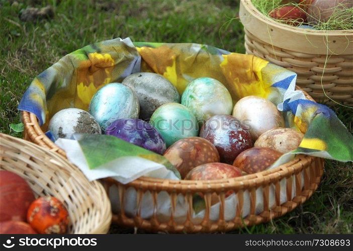 Painted eggs at Easter. Easter eggs in basket on green grass.