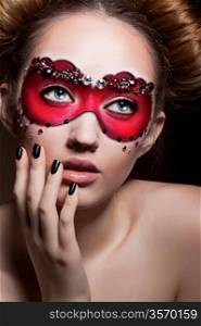 Painted Face. Beautiful Girl in Red Carnival Mask. Masquerade