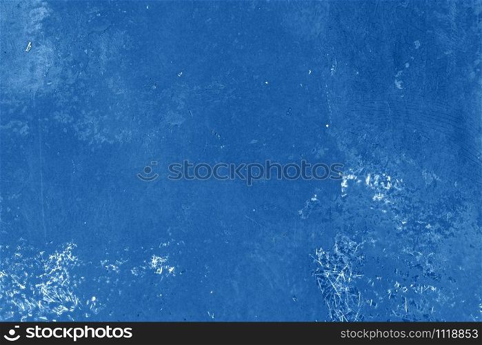 Painted scratched and peeled grunge surface background. Color of the year 2020 classic blue toned