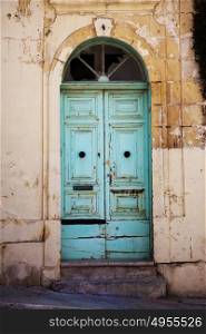 Painted turquoise door Gozo Malta to an old run down house