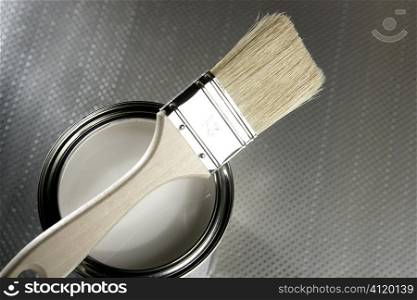 Painter brush and white paint tin