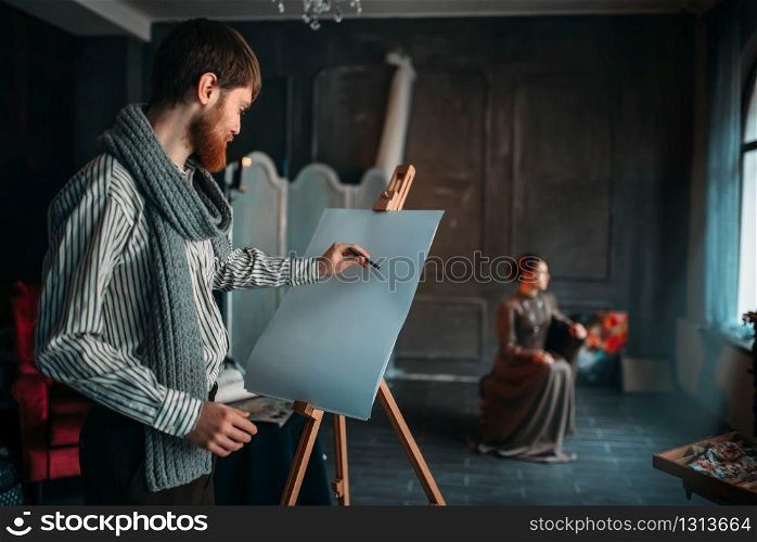 Painter drawing female portrait against easel in art studio. Oil paint