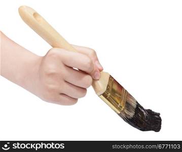 painter hand holds brush with black paint isolated on white background