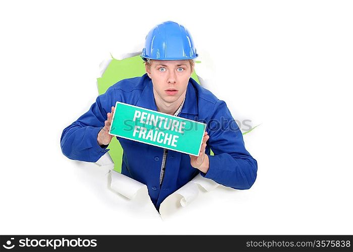 Painter holding a fresh paint sign.