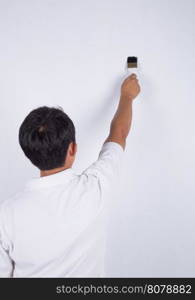 painter man at work with a Brush painting on wall background