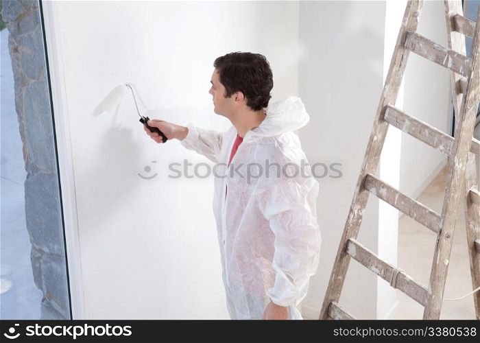 Painter painting the wall with roller