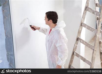 Painter painting the wall with roller