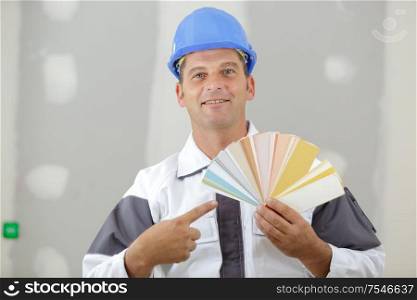 painter pointing at colours for painting job