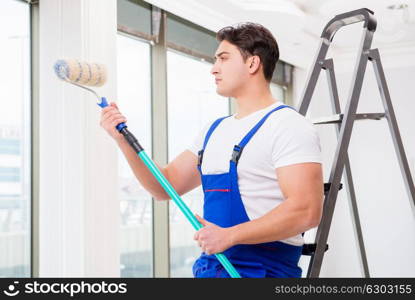 Painter repairman working at construction site. The painter repairman working at construction site