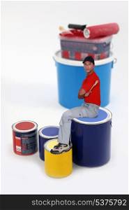 Painter sitting on paint can