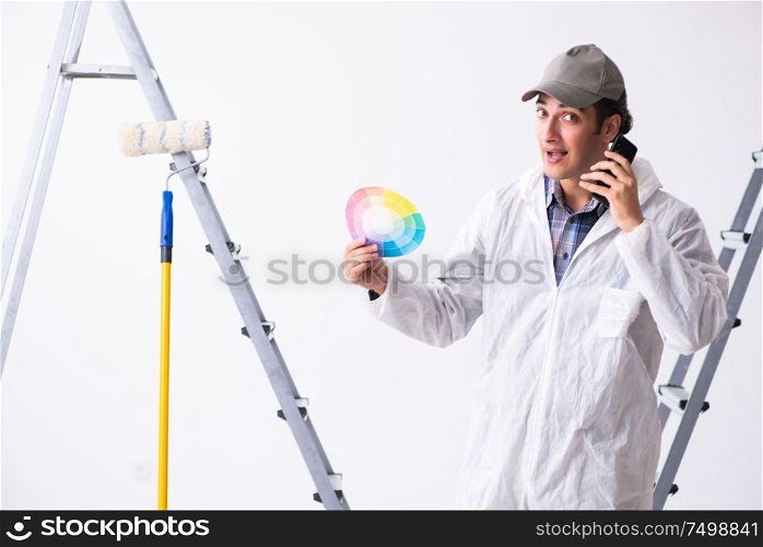 Painter working at the construction site. Painter working at construction site