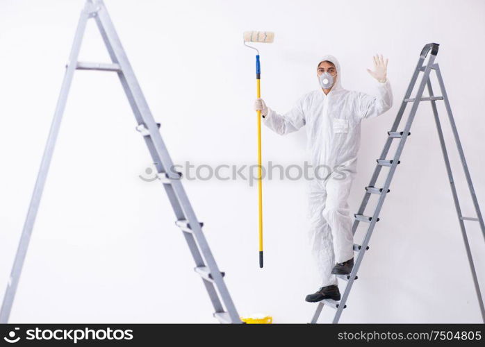 Painter working at the construction site. Painter working at construction site