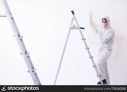 Painter working at the construction site. Painter working at construction site