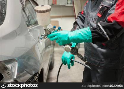 painting a car. spray gun with paint for painting a car