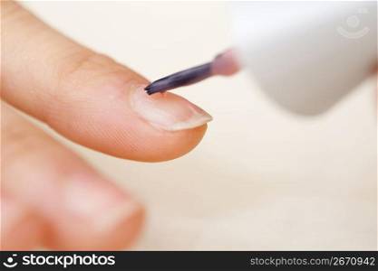 painting a nail with nail varnish