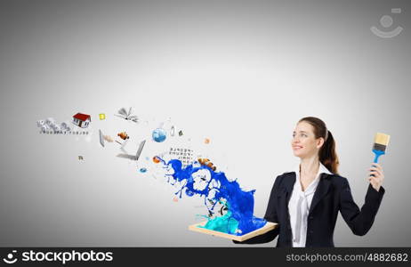 Painting art. Young businesswoman holding paint brush and wooden frame