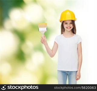 painting, building, childhood and people concept - smiling little girl in protective helmet with paint brush