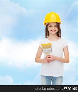 painting, building, childhood and people concept - smiling little girl in protective helmet with paint brush