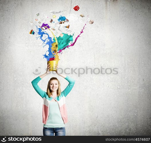 Painting concept. Young girl holding bucket with colorful splashes