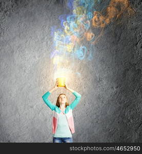 Painting concept. Young girl holding bucket with colorful splashes