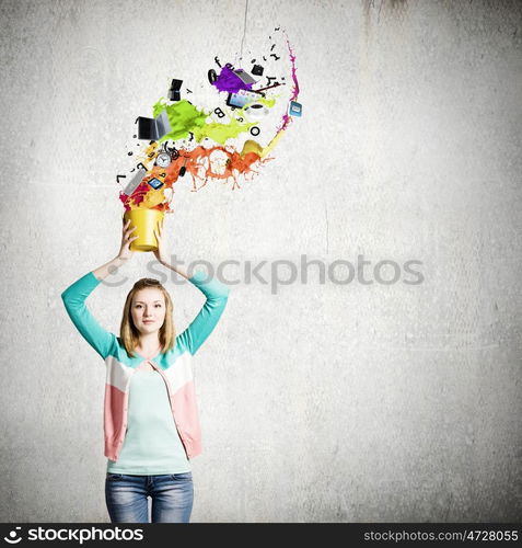 Painting concept. Young girl holding bucket with colorful splashes