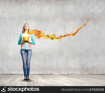 Painting concept. Young girl holding bucket with colorful splashes