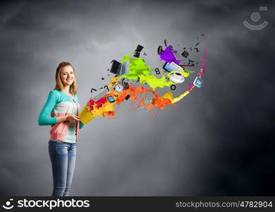 Painting concept. Young girl holding bucket with colorful splashes