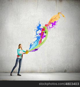 Painting concept. Young girl holding bucket with colorful splashes