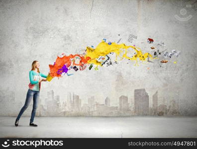 Painting concept. Young girl holding bucket with colorful splashes