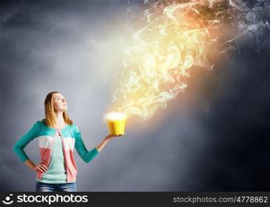 Painting concept. Young girl holding bucket with flying out fume