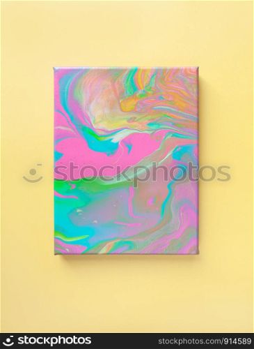 Painting in bright pastel colors on wall using liquid fluid art trendy technique. Central composition. View opposite. Flat lay. Close-up. Concept contemporary art accessible to everyone.