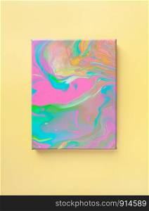 Painting in bright pastel colors on wall using liquid fluid art trendy technique. Central composition. View opposite. Flat lay. Close-up. Concept contemporary art accessible to everyone.