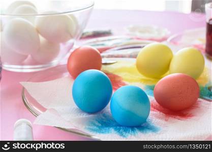 Painting in different colors of eggs for Easter