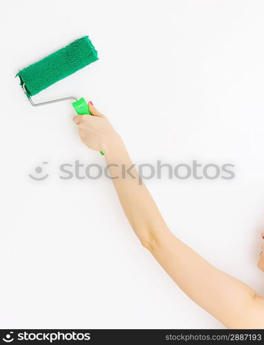 Painting interior wall of home with paint roller