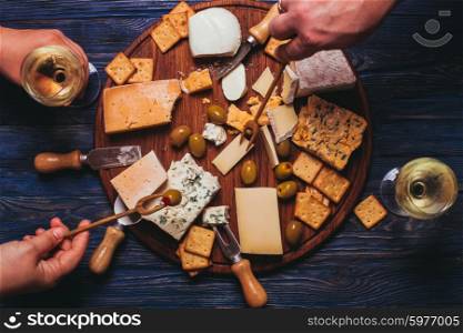 Pair have a nice evening with cheese plate and wine. Cheese plate